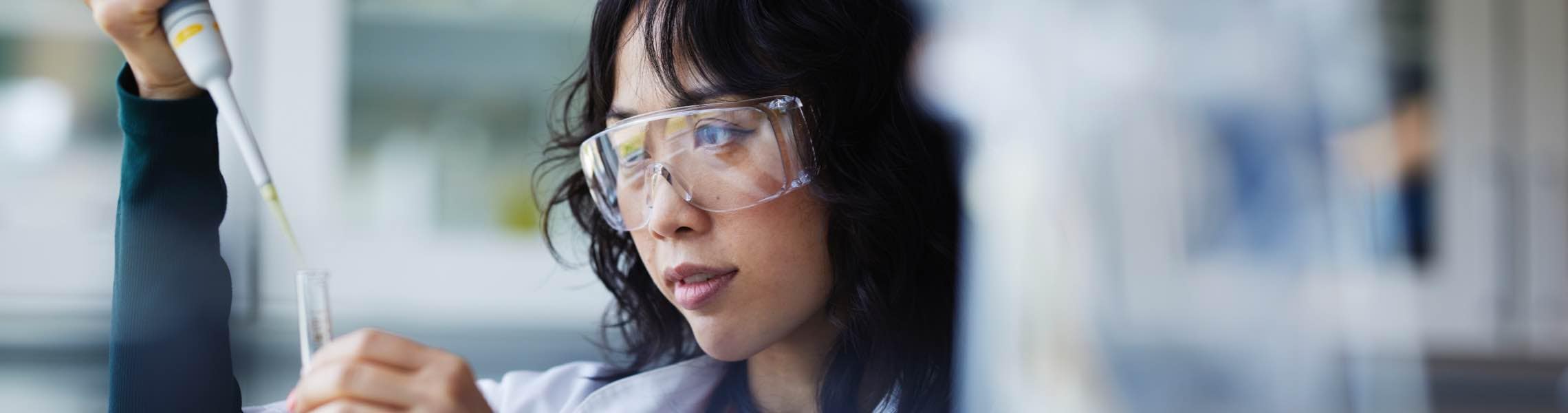 Woman in goggles working in medical lab