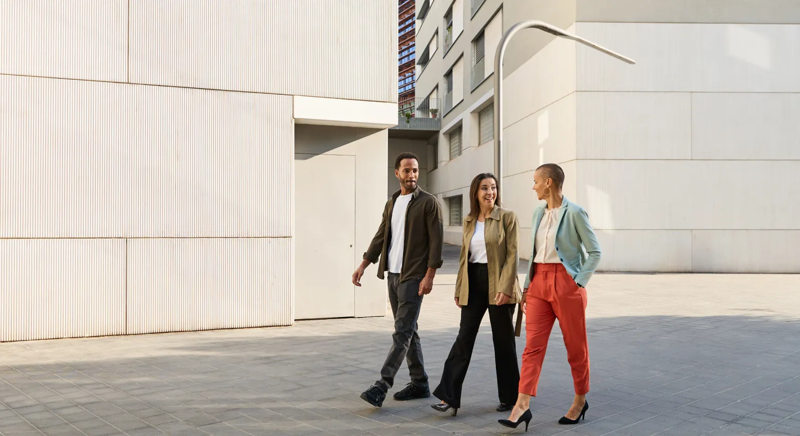 Coworkers walking outside building  