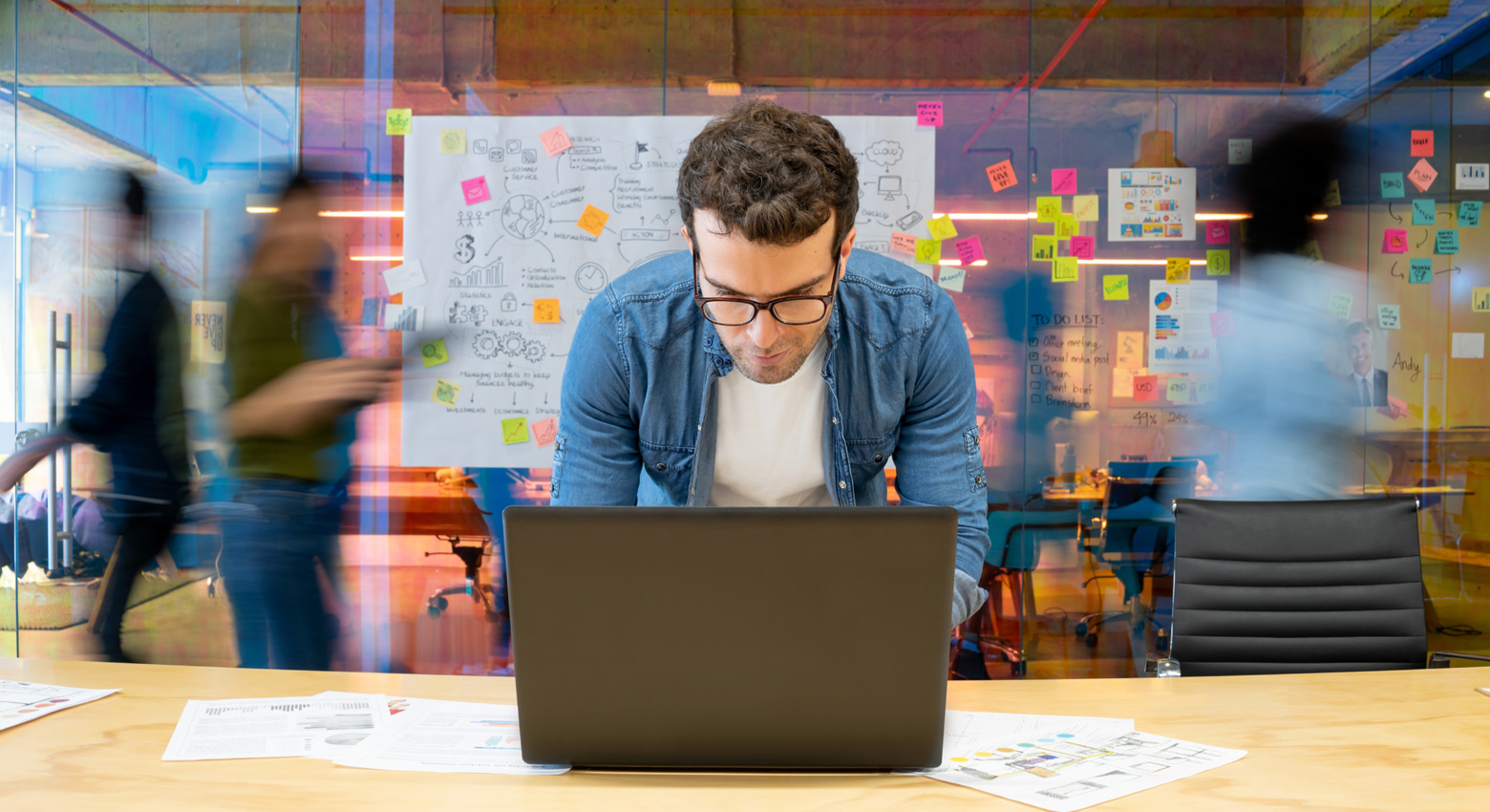 Man with glasses working on computer 