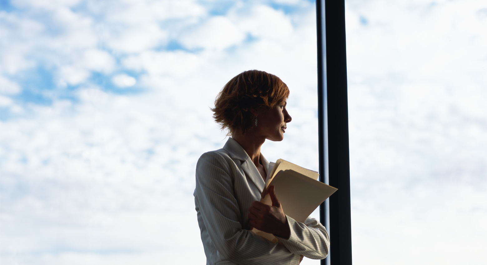 Businesswoman looking out of window