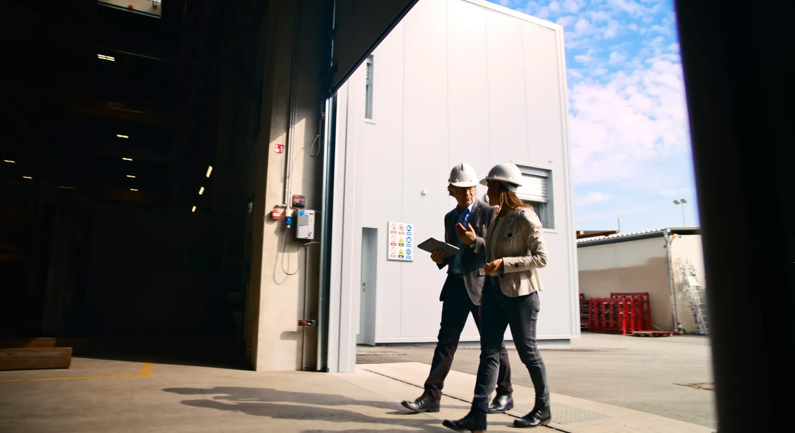 Men and woman hard hats hangar door