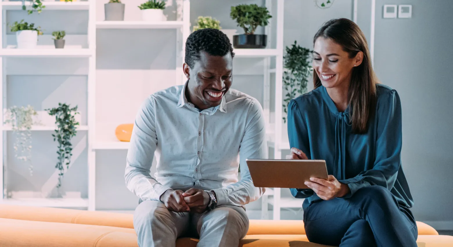 man and woman looking at a tablet