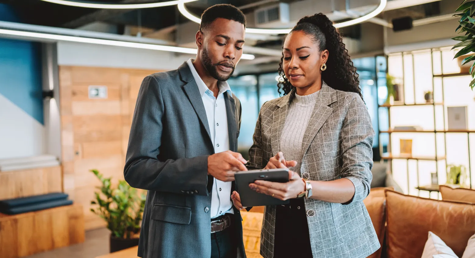 Man and woman looking at tablet 