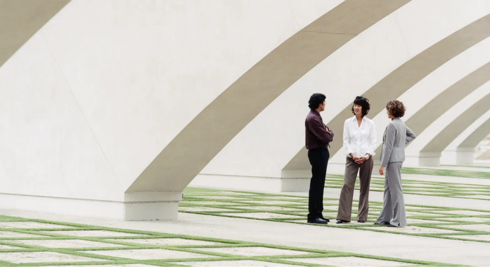 People standing under modern architecture 