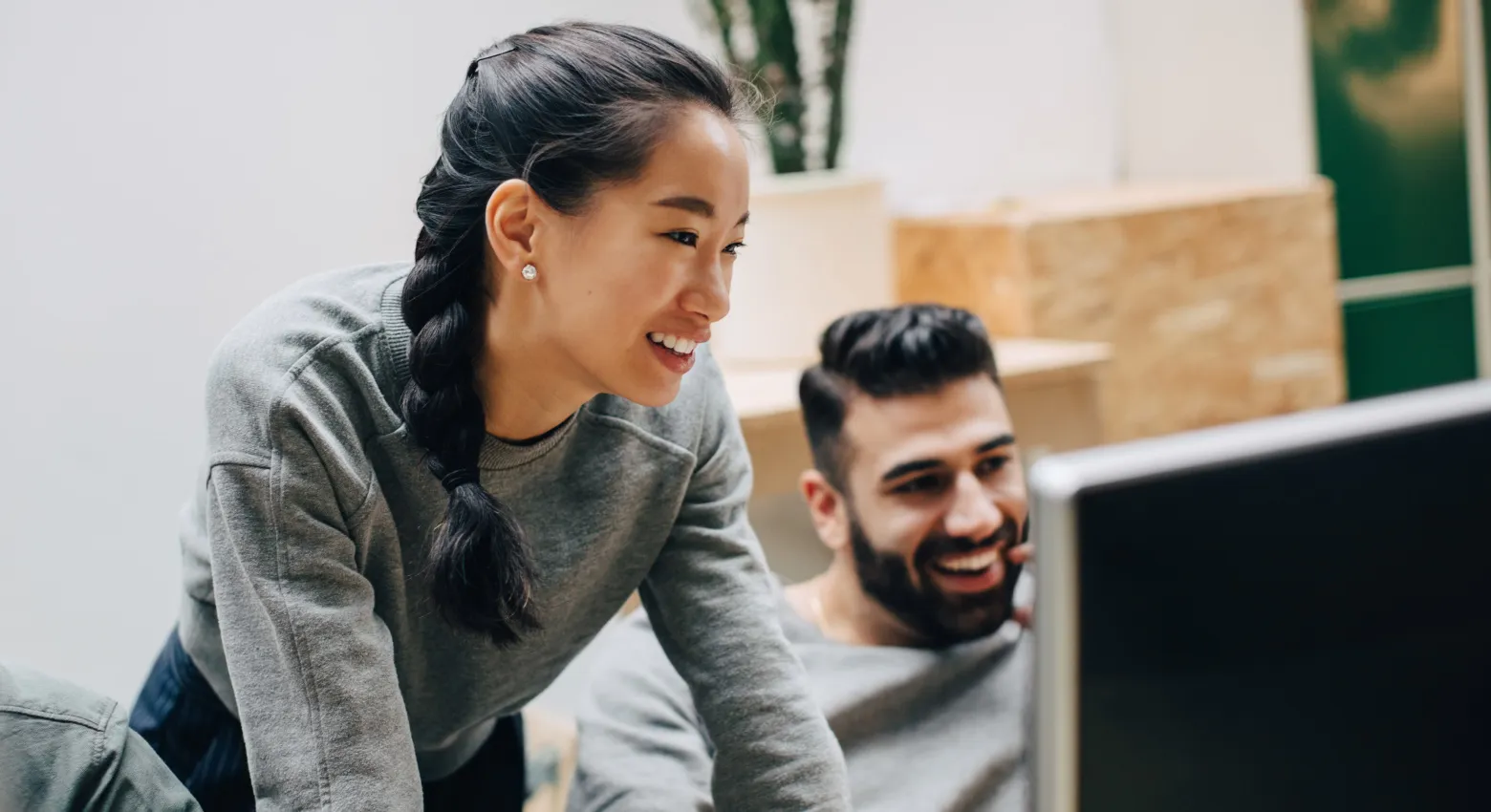 Woman and man working on computer together 