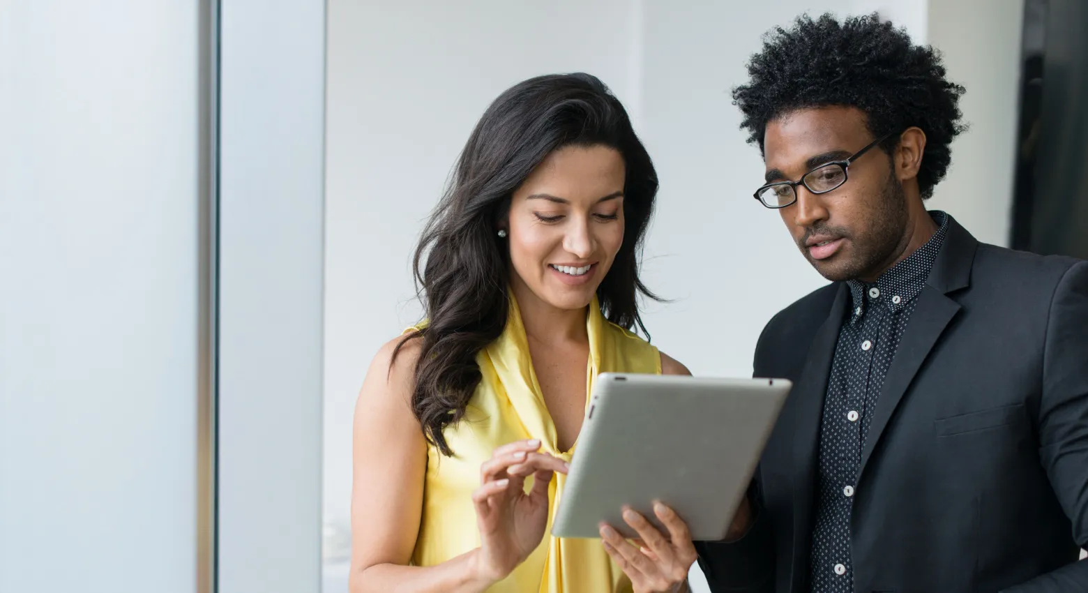 Woman and man working on tablet together 