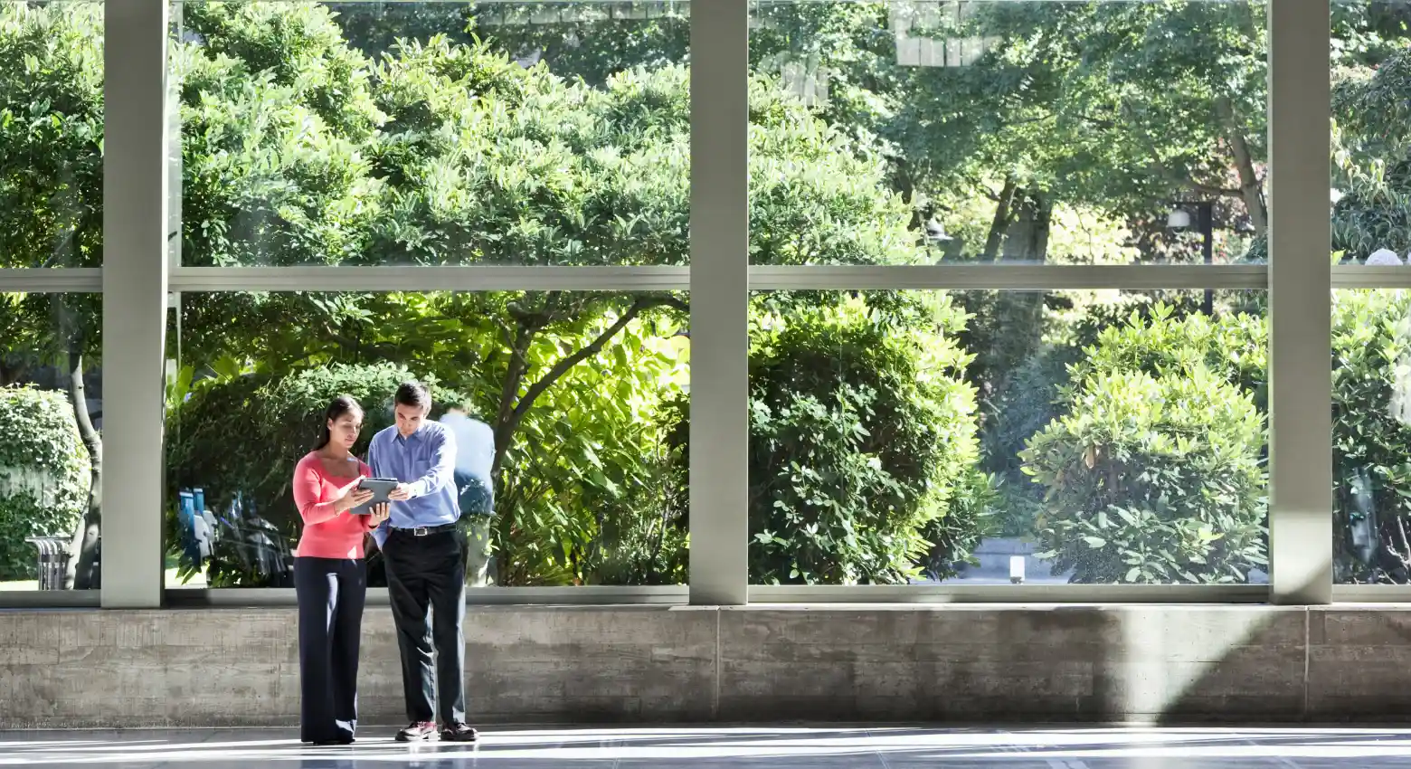 man and woman looking at a tablet