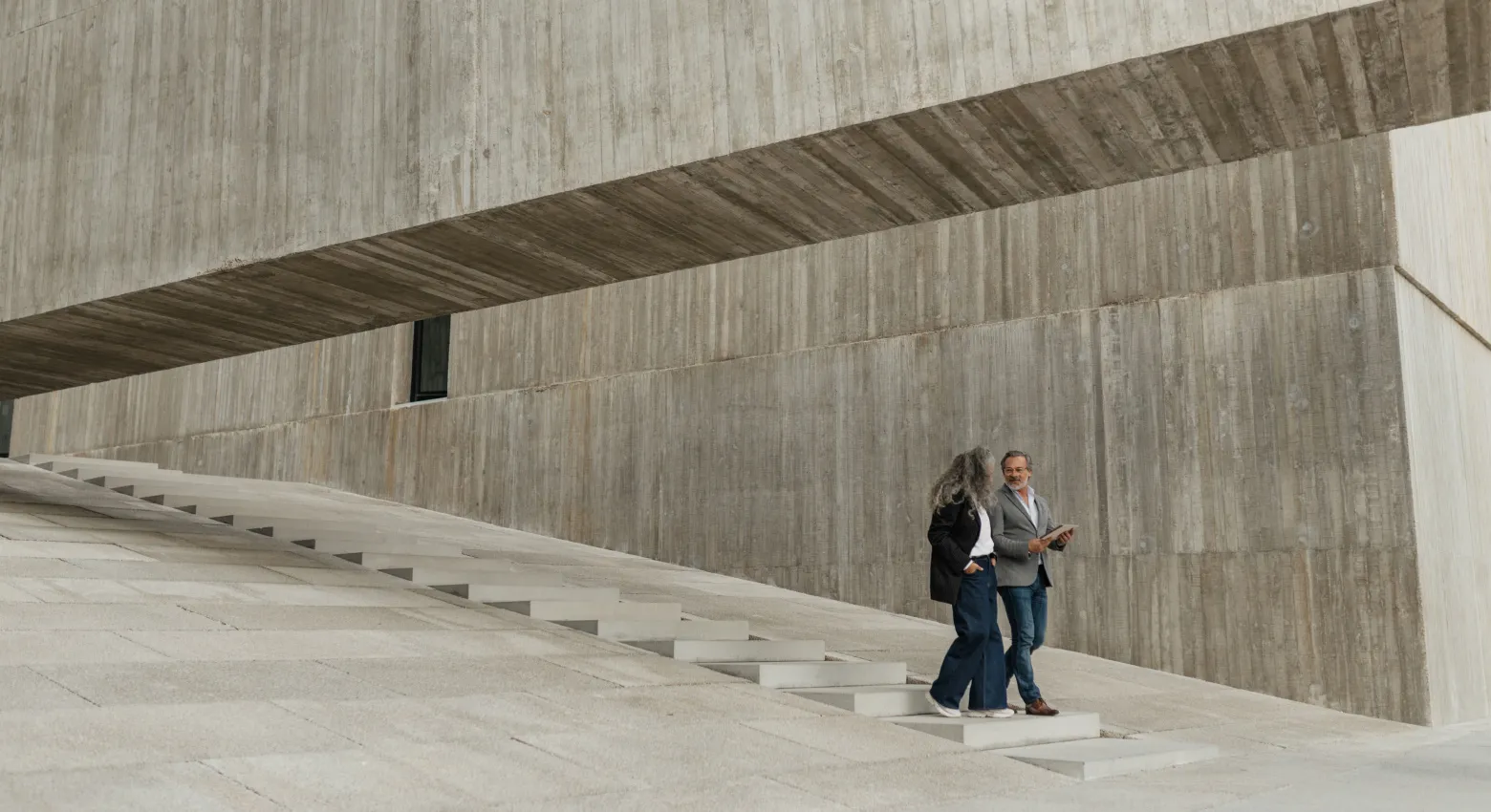 Men and woman walking downstairs