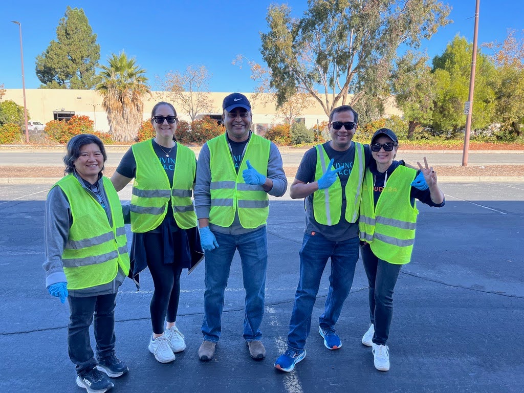 Volunteers posing in green vests 