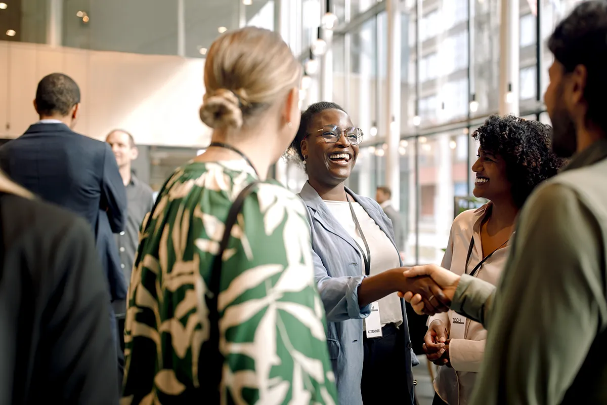 A group of professionals meet and network.