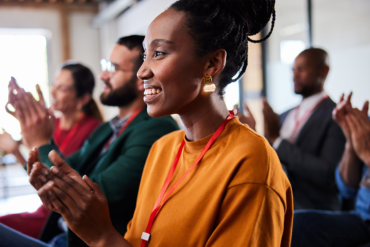 Woman clapping at an event setting