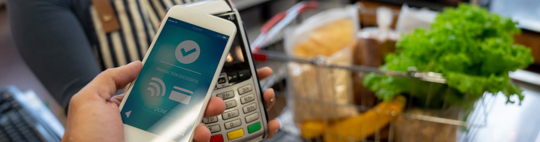 Someone paying for groceries with their mobile device