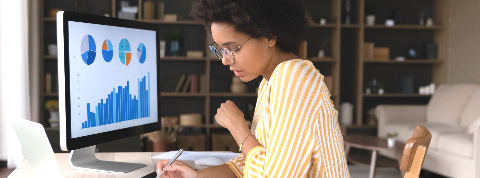 Woman working at her design with analytics on her computer