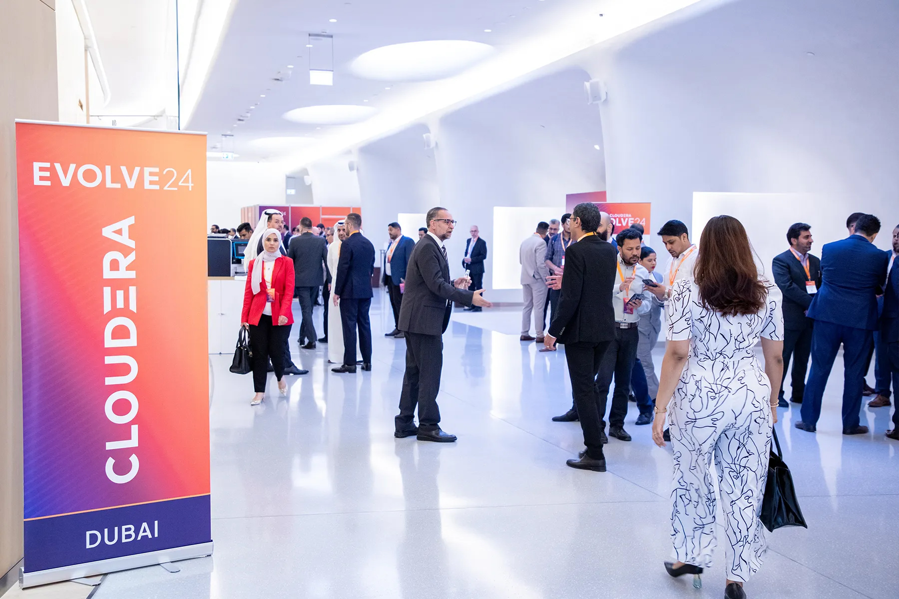 Evolve Dubai attendees in the event space learn more