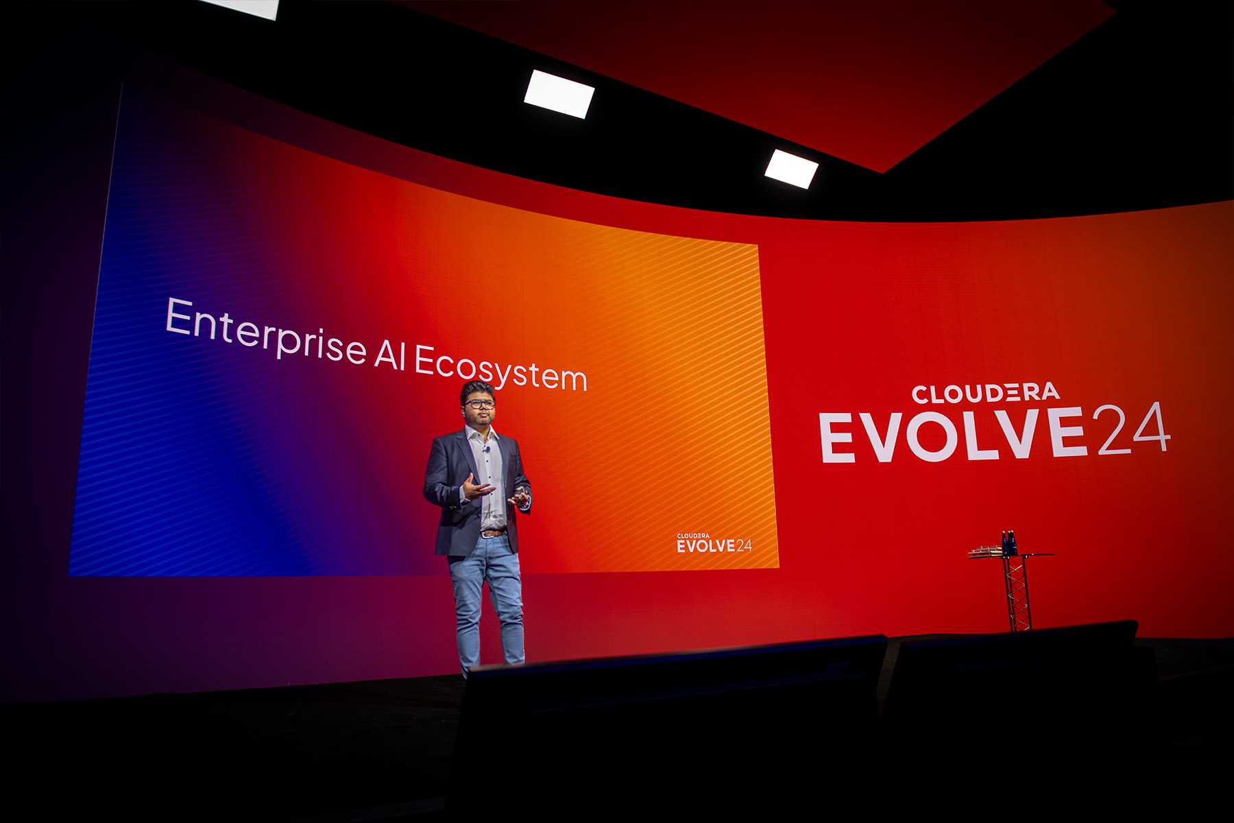Speaker Abhas on the main stage at Evolve