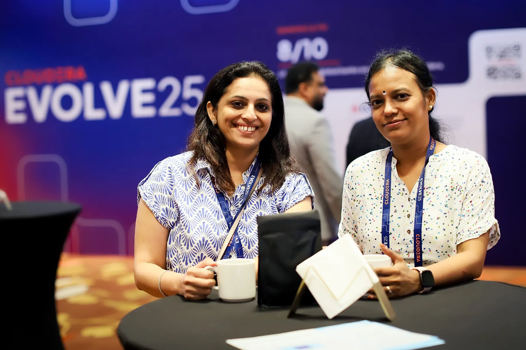 Two attendees at the Evolve Singapore expo booth space