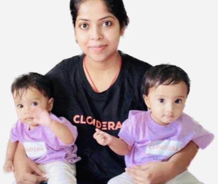 Employee wearing a Cloudera shirt with her twins in her lap